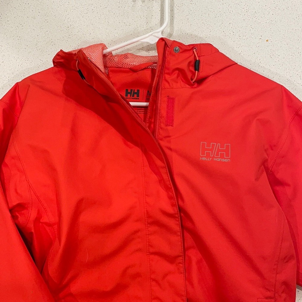 Salmon colored, lightly worn Helly Hansen wind/rain coat/shell.